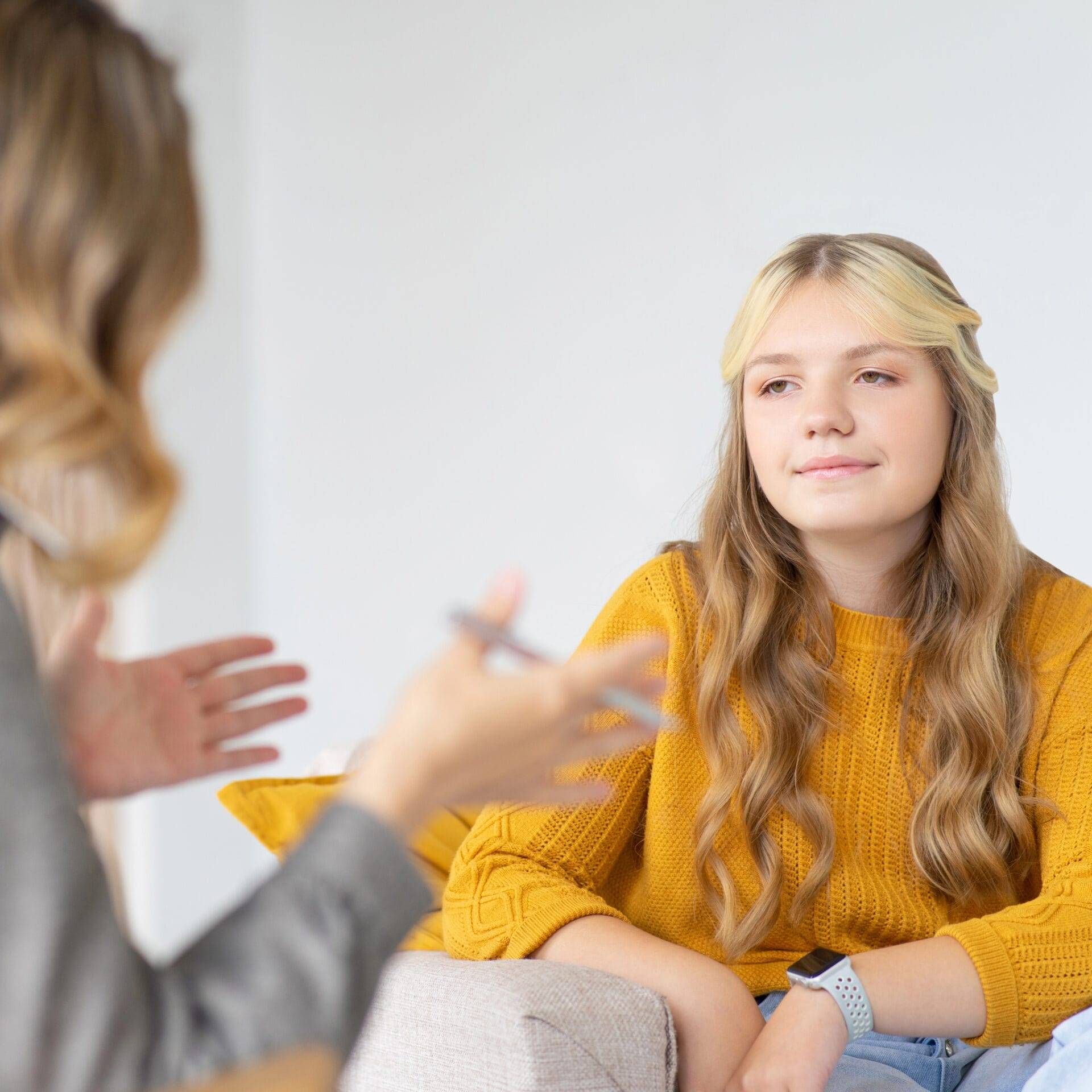 Talking Therapy (SQ) - Clinician talking to young adult client Therapist talking to client in a mental health clinic