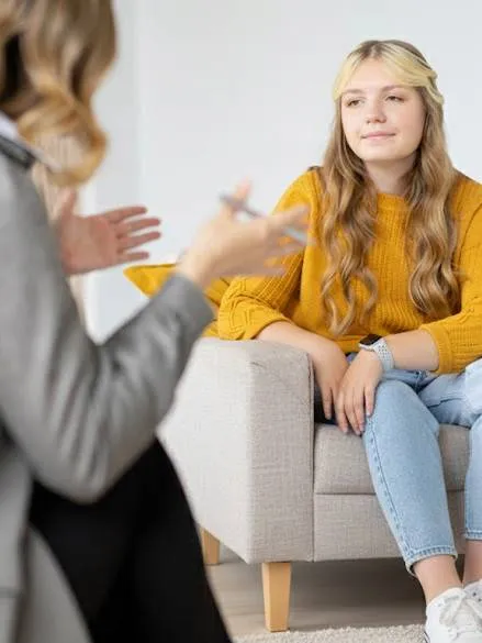 Therapist talking to a client in at the Purple House mental health clinic